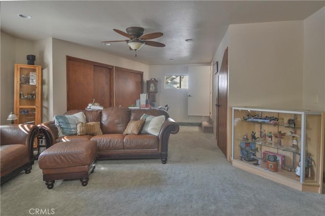 living room featuring ceiling fan and light colored carpet