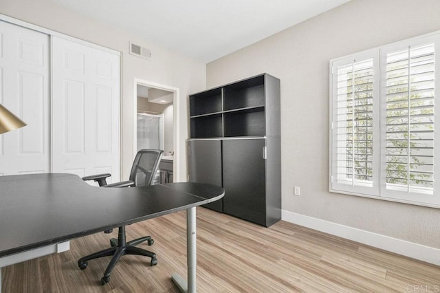 office with light wood-type flooring