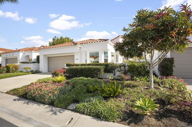 mediterranean / spanish-style home with a garage