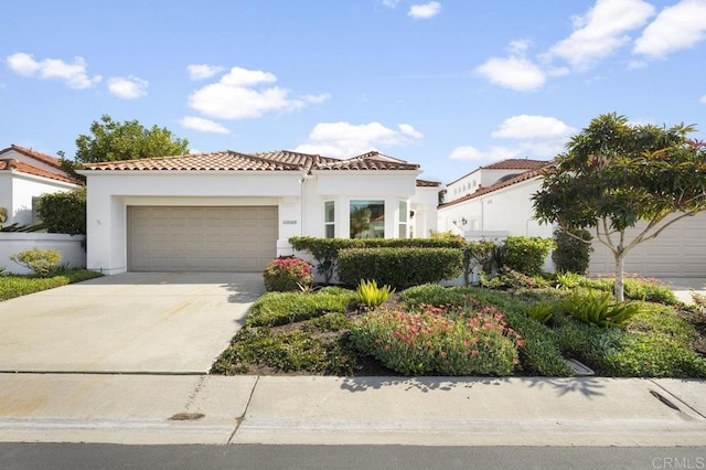 mediterranean / spanish house with a garage