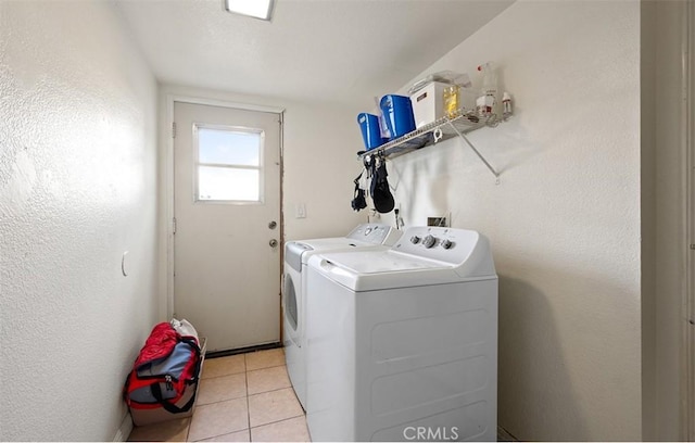 laundry area with light tile patterned floors and independent washer and dryer