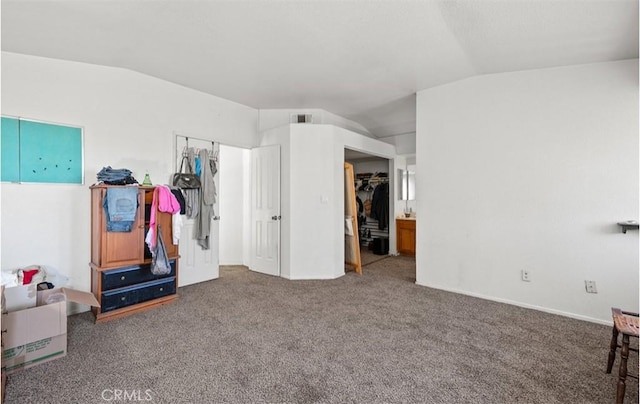 carpeted bedroom with lofted ceiling