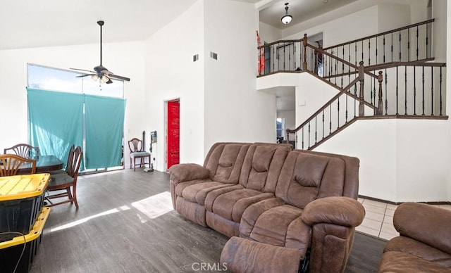 living room with ceiling fan, hardwood / wood-style floors, and high vaulted ceiling