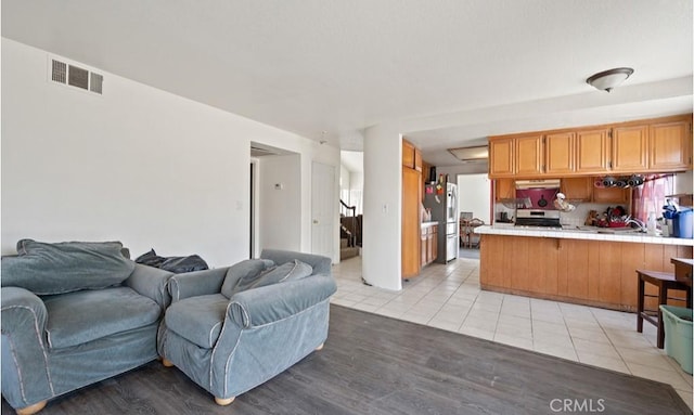 living room featuring light tile patterned floors and sink