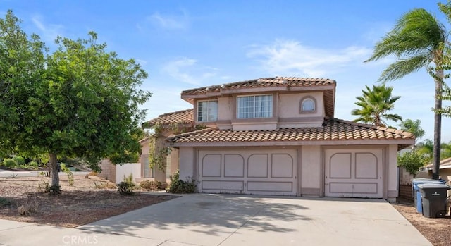 mediterranean / spanish house with a garage