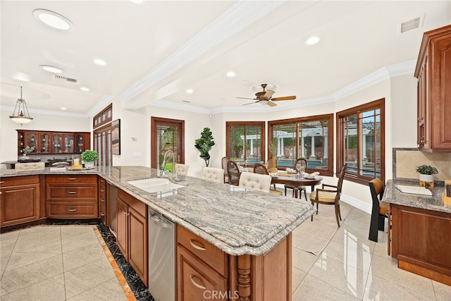 kitchen featuring sink, ornamental molding, and stainless steel dishwasher