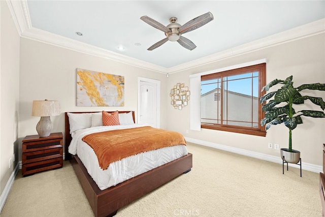 carpeted bedroom with ornamental molding and ceiling fan