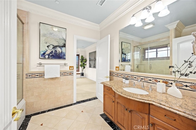 bathroom featuring an enclosed shower, tile walls, ornamental molding, vanity, and tile patterned flooring