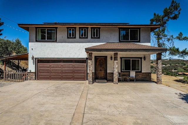 view of front of home featuring a porch and a garage