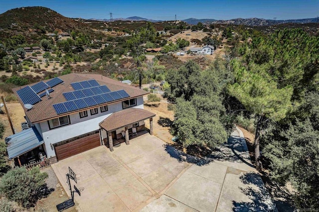 birds eye view of property with a mountain view