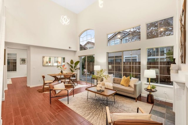 living room with hardwood / wood-style flooring and a towering ceiling