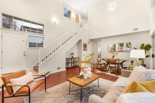 living room with hardwood / wood-style flooring and a high ceiling