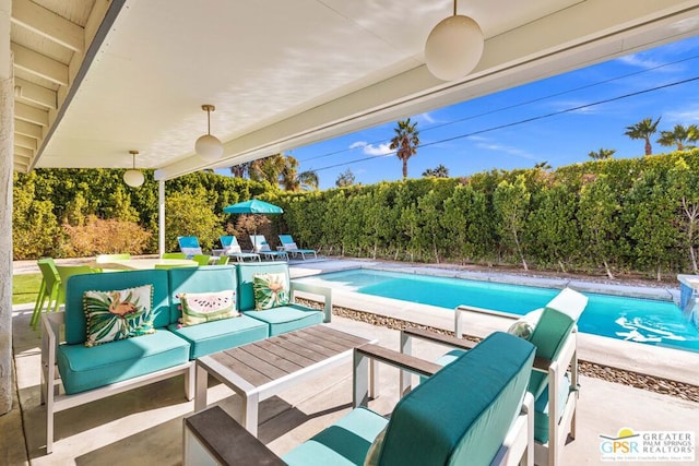 view of swimming pool featuring an outdoor living space and a patio area