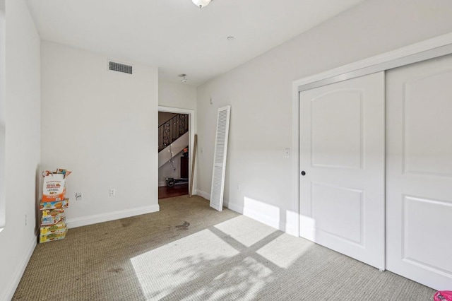 unfurnished bedroom featuring light colored carpet