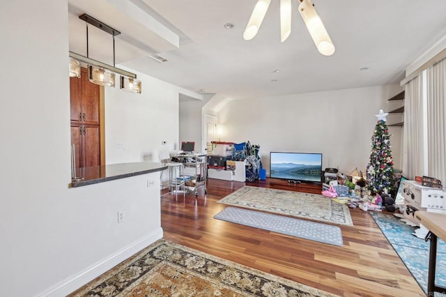 living room featuring wood-type flooring and ceiling fan