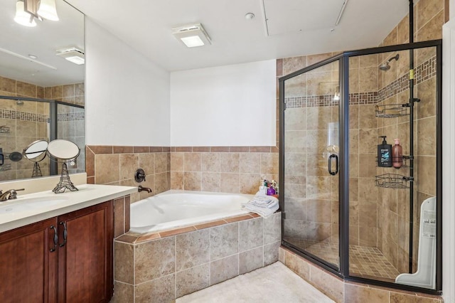 bathroom with vanity and separate shower and tub