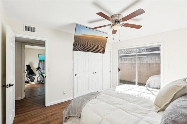 bedroom with a ceiling fan, baseboards, visible vents, and wood finished floors