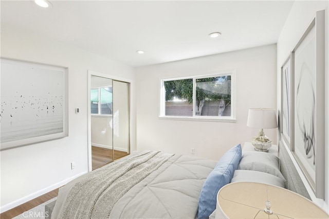 bedroom with recessed lighting, baseboards, and wood finished floors