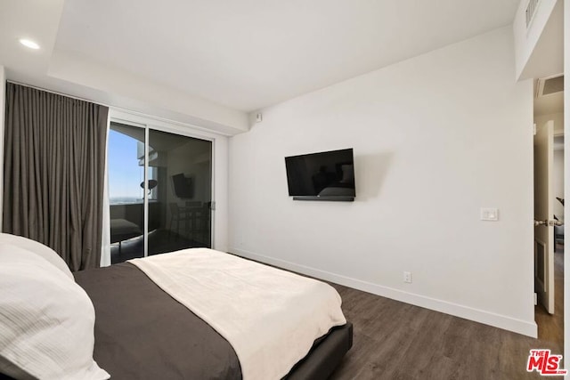 bedroom with dark hardwood / wood-style floors