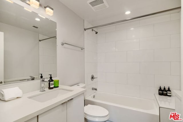 full bathroom featuring vanity, toilet, and tiled shower / bath