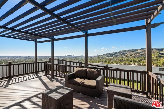 deck with a pergola and outdoor lounge area