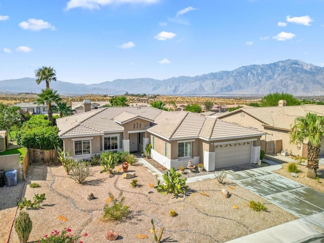 view of front of home with a garage and a mountain view