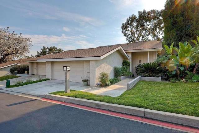 single story home featuring a garage and a front lawn