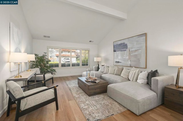 living room featuring hardwood / wood-style floors and vaulted ceiling with beams