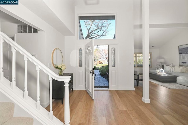 entrance foyer featuring a high ceiling and light wood-type flooring