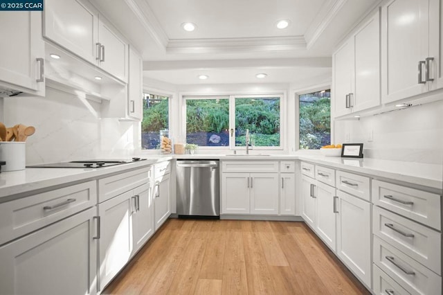 kitchen with white cabinetry, sink, stainless steel dishwasher, black electric stovetop, and a raised ceiling