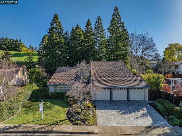 view of front of home with a garage and a front lawn