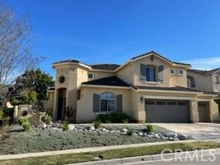 mediterranean / spanish home featuring a garage