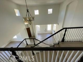 stairway with a notable chandelier