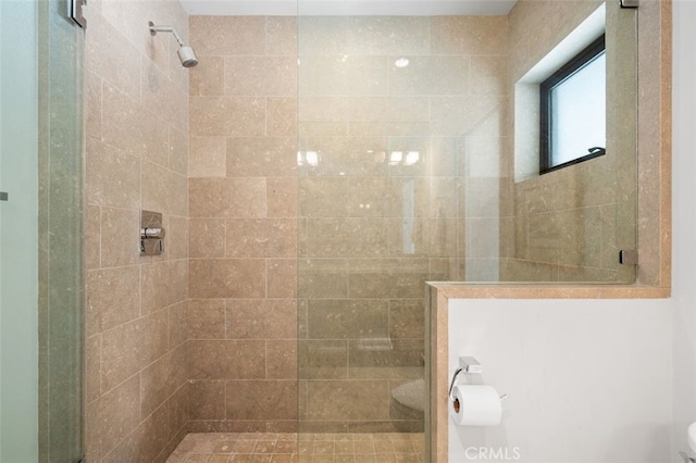 bathroom with a tile shower