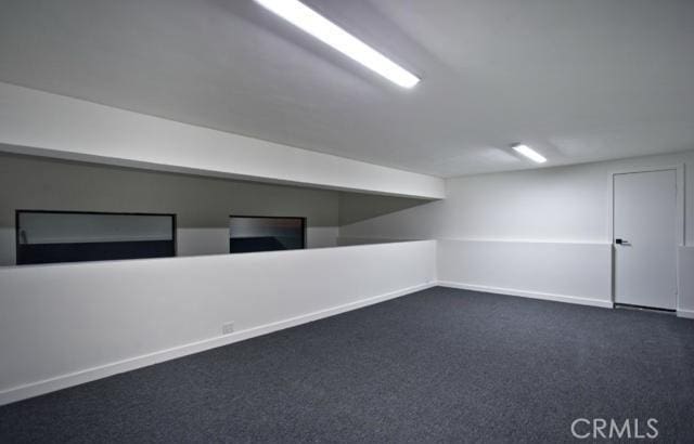 interior space with dark colored carpet