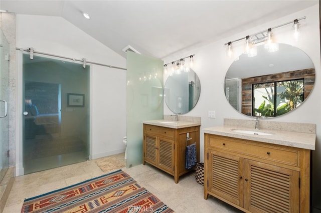 bathroom with vanity, lofted ceiling, an enclosed shower, and toilet