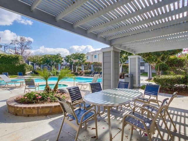 view of patio with a community pool and a pergola