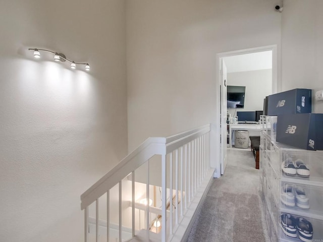 hallway featuring light colored carpet