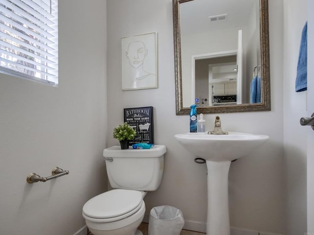 half bath with visible vents and toilet