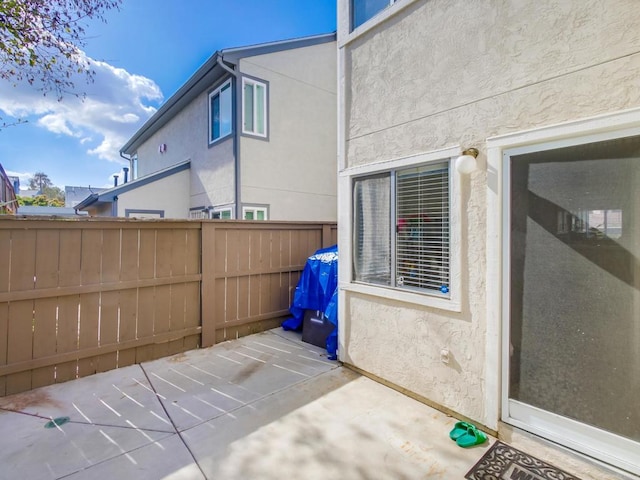 view of patio featuring fence