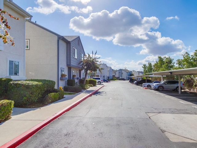 view of road featuring sidewalks, a residential view, and curbs