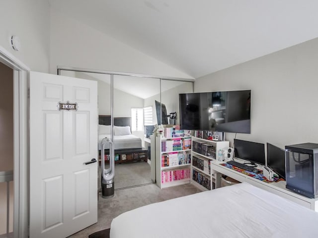 bedroom with lofted ceiling, a closet, and carpet flooring