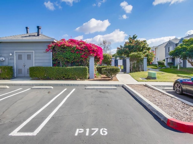 uncovered parking lot with a residential view