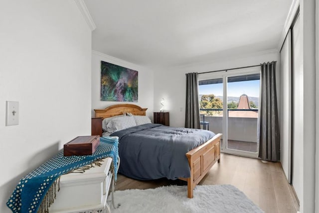 bedroom with access to exterior, ornamental molding, and light hardwood / wood-style floors