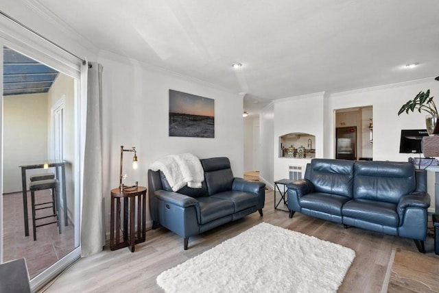 living room featuring hardwood / wood-style flooring and ornamental molding