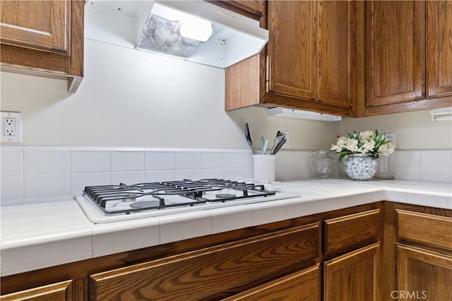 kitchen with gas stovetop and tile countertops