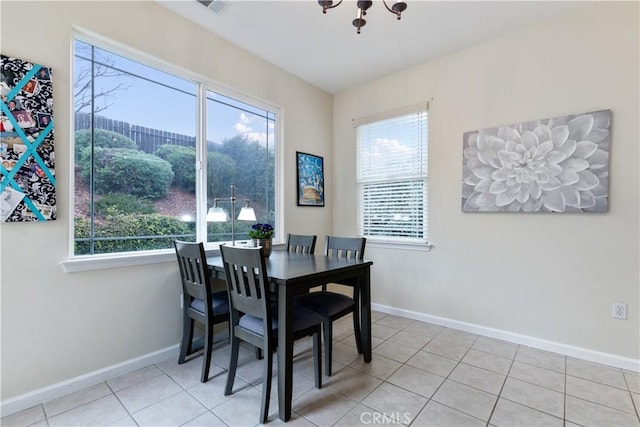 dining room with an inviting chandelier and light tile patterned floors