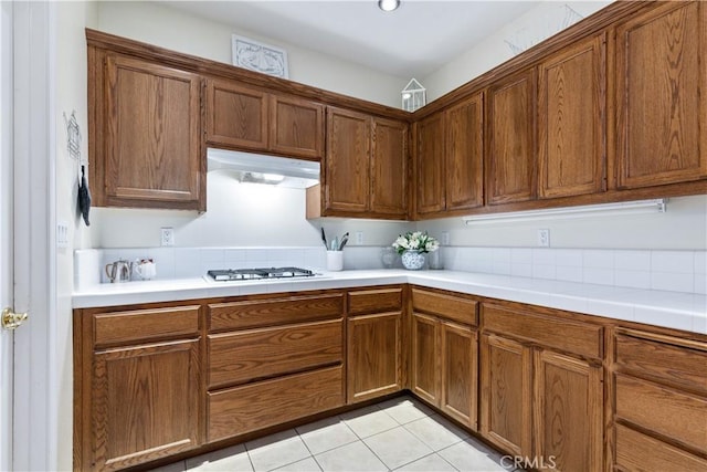 kitchen featuring stainless steel gas stovetop and light tile patterned flooring