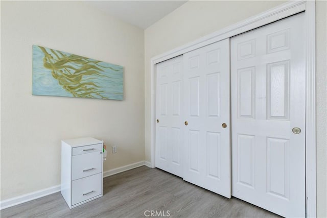 unfurnished bedroom featuring a closet and light hardwood / wood-style flooring