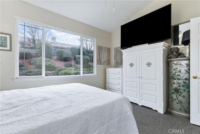 carpeted bedroom with vaulted ceiling